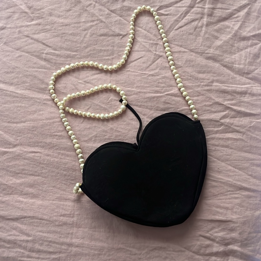 DONNI. Black Accessory with Cream Label